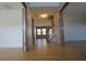 Inviting hallway featuring wood floors and staircase leading to the upper level of the home at 838 Roxholly Ln, Buford, GA 30518