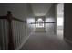 Hallway on the second floor of this home has carpet floors and a unique light fixture at 838 Roxholly Ln, Buford, GA 30518