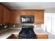 Kitchen featuring wood cabinets, modern appliances and plenty of counter space at 838 Roxholly Ln, Buford, GA 30518