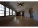 Spacious living room with wood floors, bright windows, and seamless flow to the kitchen at 838 Roxholly Ln, Buford, GA 30518