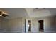 Spacious main bedroom with plush carpet, ceiling fan, and tray ceiling at 838 Roxholly Ln, Buford, GA 30518