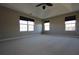 Spacious main bedroom with plush carpet, ceiling fan, and plenty of natural light at 838 Roxholly Ln, Buford, GA 30518