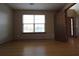 Cozy room with wood floors, window providing natural light, and neutral wall paint at 838 Roxholly Ln, Buford, GA 30518