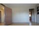 Bright room with wood flooring, connecting door, and neutral walls at 838 Roxholly Ln, Buford, GA 30518