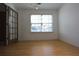 Inviting room with a large window offering nice views and wood flooring at 838 Roxholly Ln, Buford, GA 30518