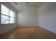 Well-lit room featuring wood floors, natural light from a window, and neutral walls at 838 Roxholly Ln, Buford, GA 30518
