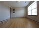 Bright, neutral room with beautiful wood floors and a view from the window at 838 Roxholly Ln, Buford, GA 30518