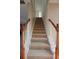 Carpeted staircase with stained wood banister and white trim details at 838 Roxholly Ln, Buford, GA 30518