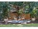 Landscaped backyard featuring a gravel seating area with chairs and potted plants, surrounded by lush greenery at 1601 Marlbrook Ne Dr, Atlanta, GA 30307