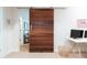 Home office features a sliding barn door, a white desk, and minimalist decor at 1601 Marlbrook Ne Dr, Atlanta, GA 30307