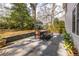 A lovely backyard with a gray stone patio, a modern dining set, and attractive landscaping at 1881 Edinburgh Ne Ter, Atlanta, GA 30307