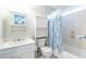 Bright bathroom featuring a shower tub combination, sink and modern designed mirror cabinet at 1881 Edinburgh Ne Ter, Atlanta, GA 30307