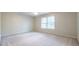 A spacious bedroom featuring ample natural light, ceiling fan, and light-colored carpeting at 1881 Edinburgh Ne Ter, Atlanta, GA 30307