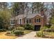 Charming brick home with a well-manicured front yard and mature trees offering shade and curb appeal at 1881 Edinburgh Ne Ter, Atlanta, GA 30307