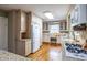 Well-lit kitchen with granite countertops, wooden cabinets, stainless steel appliances, and hardwood floors at 1881 Edinburgh Ne Ter, Atlanta, GA 30307