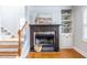 Cozy living room with a fireplace, built-in shelving, and hardwood floors, perfect for relaxation at 1881 Edinburgh Ne Ter, Atlanta, GA 30307