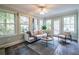 Bright sunroom with large windows, slate floors, and comfortable seating, ideal for relaxation or entertaining at 1881 Edinburgh Ne Ter, Atlanta, GA 30307