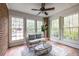 Bright sunroom with brick accent wall, tile flooring, and multiple windows for natural light at 1881 Edinburgh Ne Ter, Atlanta, GA 30307