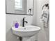 Bathroom featuring a modern pedestal sink and a mirror with dark fixtures and a hand towel at 4454 Dandelion Ln, Atlanta, GA 30342