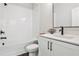 Well-lit bathroom features a white vanity with a black faucet and a white subway tile shower at 4454 Dandelion Ln, Atlanta, GA 30342