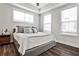 Well-lit bedroom with a comfortable bed, side table, and ample natural light from large windows at 4454 Dandelion Ln, Atlanta, GA 30342