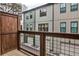 Exterior view from the balcony showcasing modern townhomes with private garages and outdoor access at 4454 Dandelion Ln, Atlanta, GA 30342