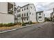 A street view of modern townhomes showcasing a neighborhood feel at 4454 Dandelion Ln, Atlanta, GA 30342