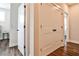 Hallway featuring hardwood floors and large closet doors, leading to other rooms at 4454 Dandelion Ln, Atlanta, GA 30342