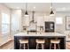 Beautiful kitchen island with bar stool seating and white subway tile back splash at 4454 Dandelion Ln, Atlanta, GA 30342