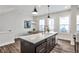 Bright, modern kitchen with an island, pendant lights, and stainless steel appliances at 4454 Dandelion Ln, Atlanta, GA 30342