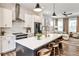 A modern kitchen featuring white cabinets, a central island with seating, and stainless steel appliances at 4454 Dandelion Ln, Atlanta, GA 30342