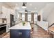 Kitchen with white cabinets and stainless steel appliances is open to the cozy living room and dining area at 4454 Dandelion Ln, Atlanta, GA 30342