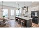 Modern kitchen with an island, stainless steel appliances, pendant lighting, and an adjacent dining area at 4454 Dandelion Ln, Atlanta, GA 30342