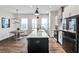 Sleek kitchen featuring stainless steel appliances, white cabinets, island seating, and a modern aesthetic at 4454 Dandelion Ln, Atlanta, GA 30342