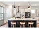Bright kitchen with white cabinets, stainless steel appliances, a dark island, and stylish pendant lighting at 4454 Dandelion Ln, Atlanta, GA 30342