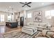 Kitchen with white cabinets and stainless steel appliances is open to the cozy living room and dining area at 4454 Dandelion Ln, Atlanta, GA 30342