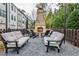 Cozy outdoor seating area featuring a stone fireplace, perfect for relaxing and entertaining guests at 4454 Dandelion Ln, Atlanta, GA 30342