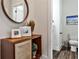 Stylish powder room with wood-look flooring, wood cabinet, round mirror, and modern fixtures at 4454 Dandelion Ln, Atlanta, GA 30342