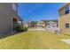 Large backyard with view of neighboring homes, grass lawn, and AC unit at 6399 Woodwell Dr, Union City, GA 30291