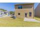 View of the home's backyard, showing a patio, lawn, and exterior at 6399 Woodwell Dr, Union City, GA 30291