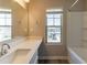 Bathroom featuring a sink, shower, and a bright window offering neighborhood views at 6399 Woodwell Dr, Union City, GA 30291