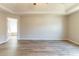 A bedroom boasts tray ceiling, a ceiling fan and neutral walls with the door opening to the Primary bath at 6399 Woodwell Dr, Union City, GA 30291