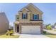 Charming two-story home showcasing a stone facade, attached garage, and a well-maintained front yard in a suburban neighborhood at 6399 Woodwell Dr, Union City, GA 30291