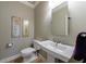 Elegant powder room with pedestal sink, decorative artwork, and modern fixtures at 1140 Matheson Way, Alpharetta, GA 30022