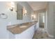 Bright bathroom with a long double vanity, granite countertop, tile floors, and decorative lighting at 1140 Matheson Way, Alpharetta, GA 30022