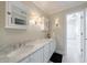 Bathroom with double vanity, marble countertops, and classic black and white flooring at 1140 Matheson Way, Alpharetta, GA 30022