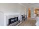 Living space showcasing a fireplace with a white mantel and hardwood floors; doorway and bench visible at 1140 Matheson Way, Alpharetta, GA 30022