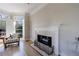 Living area showcasing a charming fireplace with marble surround, white mantel, and elegant seating at 1140 Matheson Way, Alpharetta, GA 30022