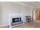 Living space with elegant fireplace, white mantel, and hardwood floors; bench and doorway visible at 1140 Matheson Way, Alpharetta, GA 30022