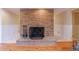 Brick fireplace with hearth in a finished basement with hardwood floors at 1140 Matheson Way, Alpharetta, GA 30022